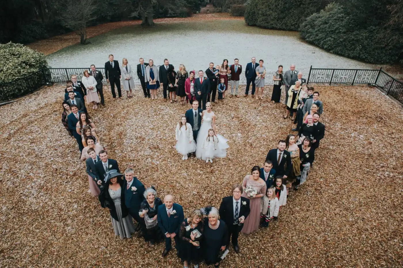 Winter Wedding - family in stood in heart formation